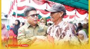 Bupati Sambas, H. Satono menyapa ramah warga pada pembagian paket sembako gratis dalam kegiatan Pasar Murah Kecamatan Tangaran, Senin (19/10/2026).